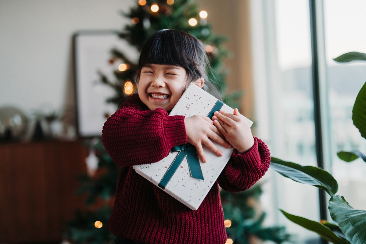 Child holding a present smiling