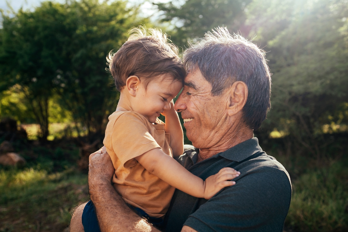 Grandfather holding his grandson smiling