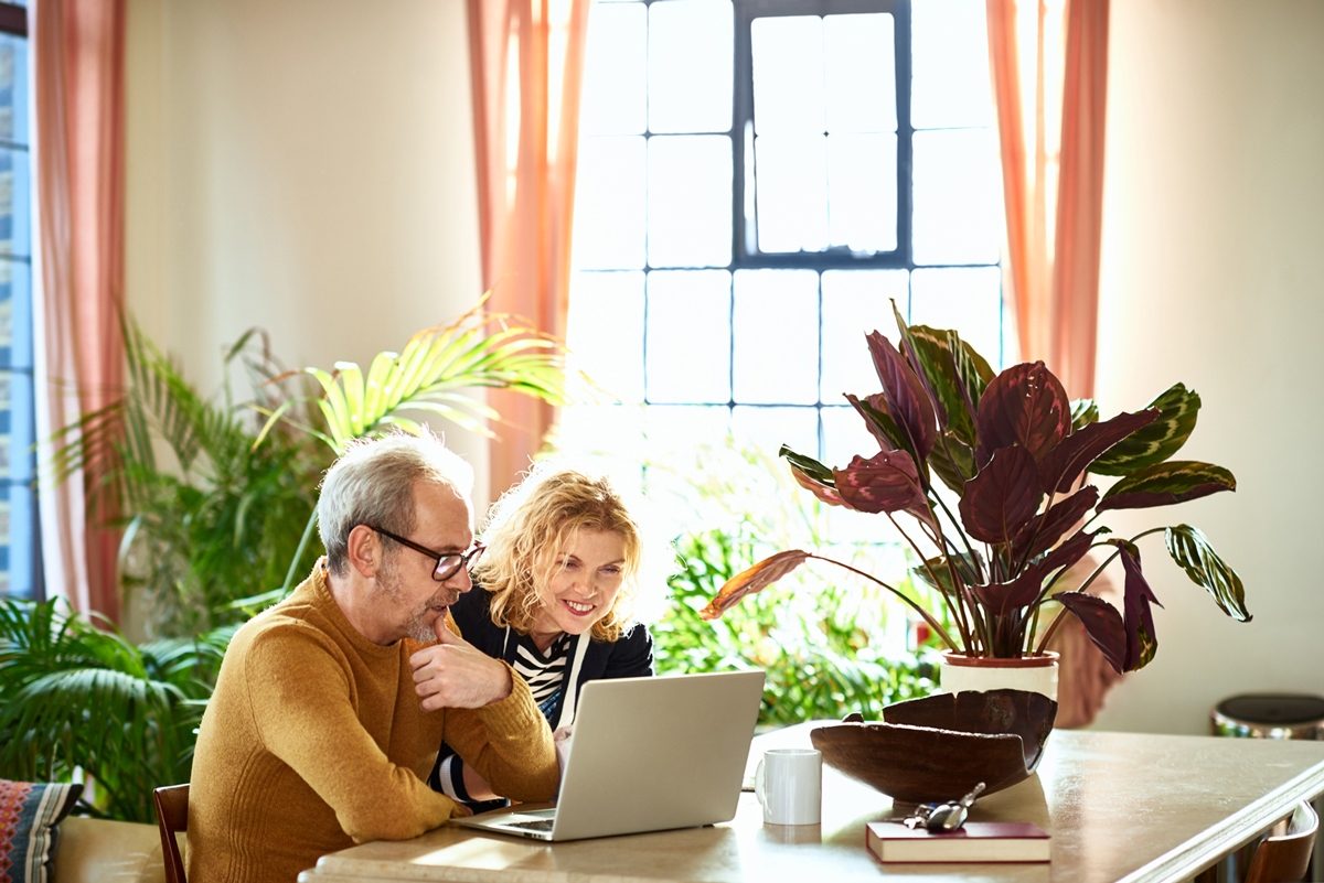Man and women looking at their laptop