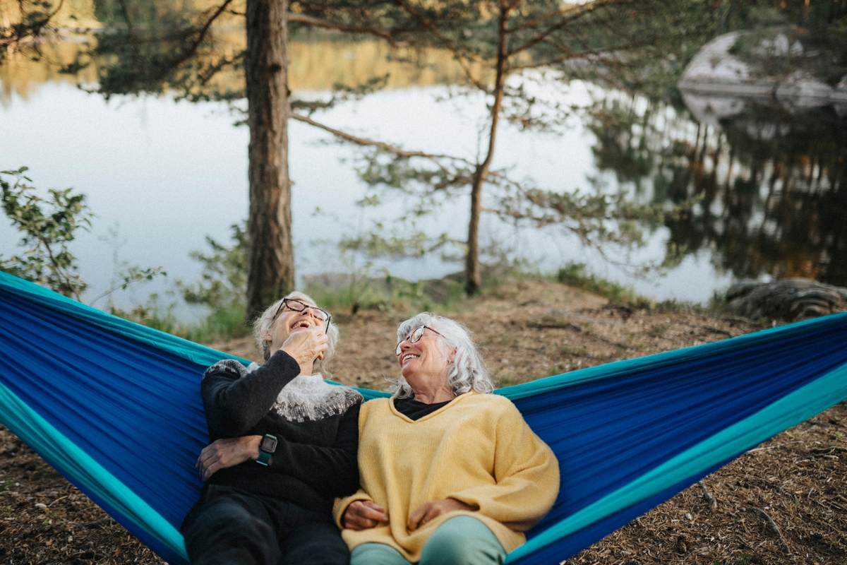 Man and women laughing on a hammock