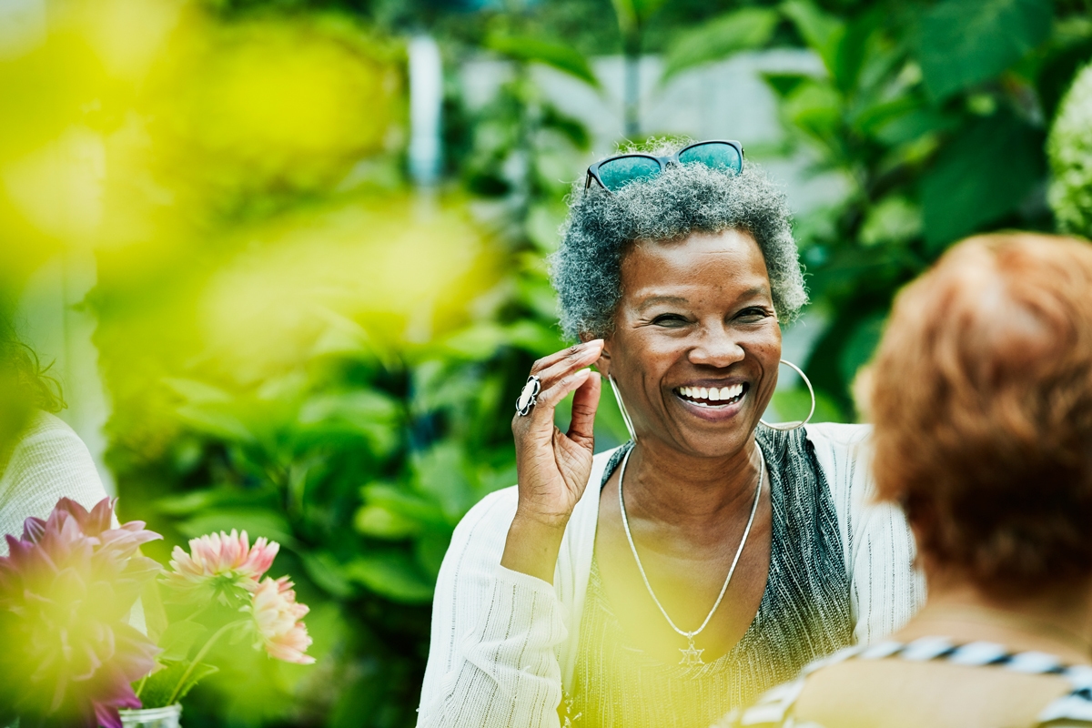 Women laughing with someone in the garden