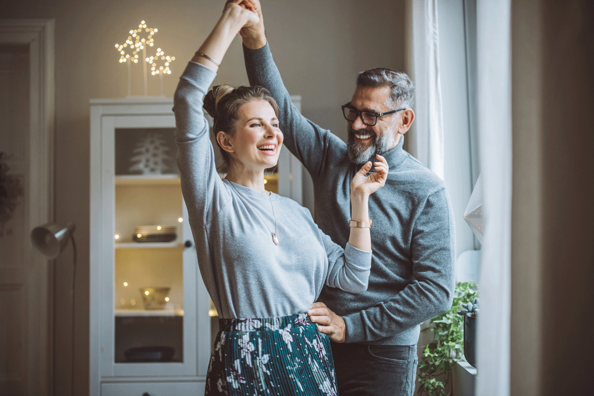Man and women dancing at home