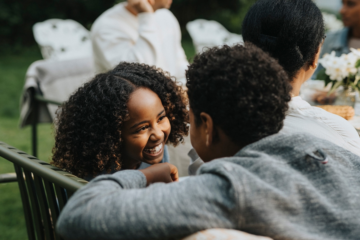 Girl smiling at a boy in the garden