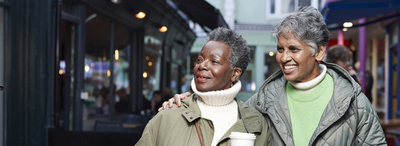 women walking in the street smiling