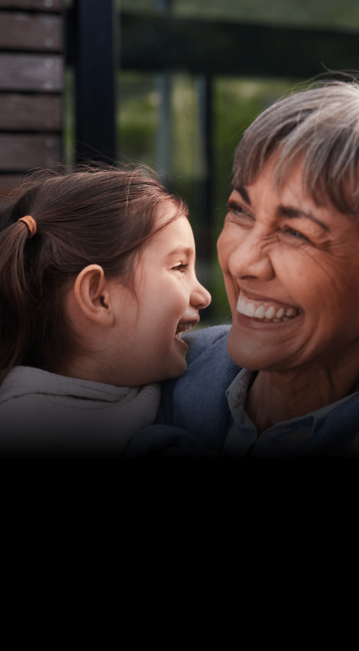Women laughing whilst holding a child