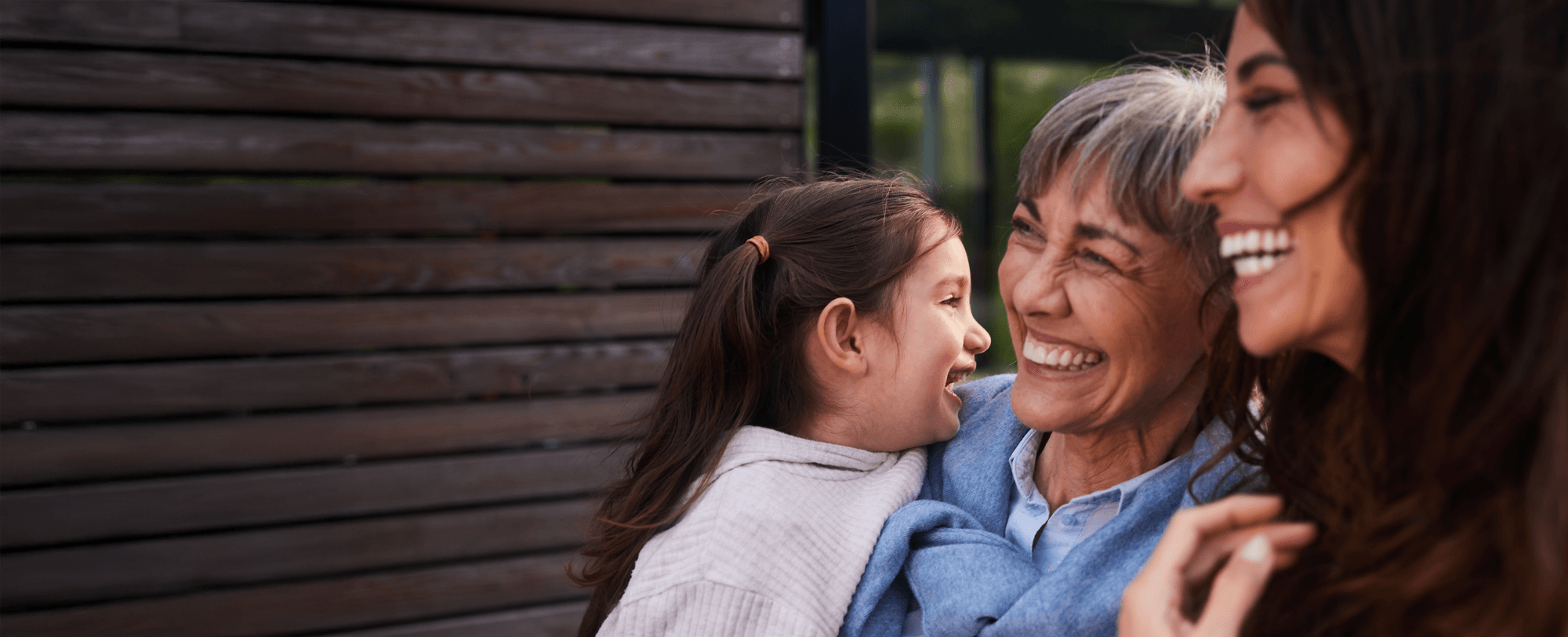 Women laughing whilst holding a child