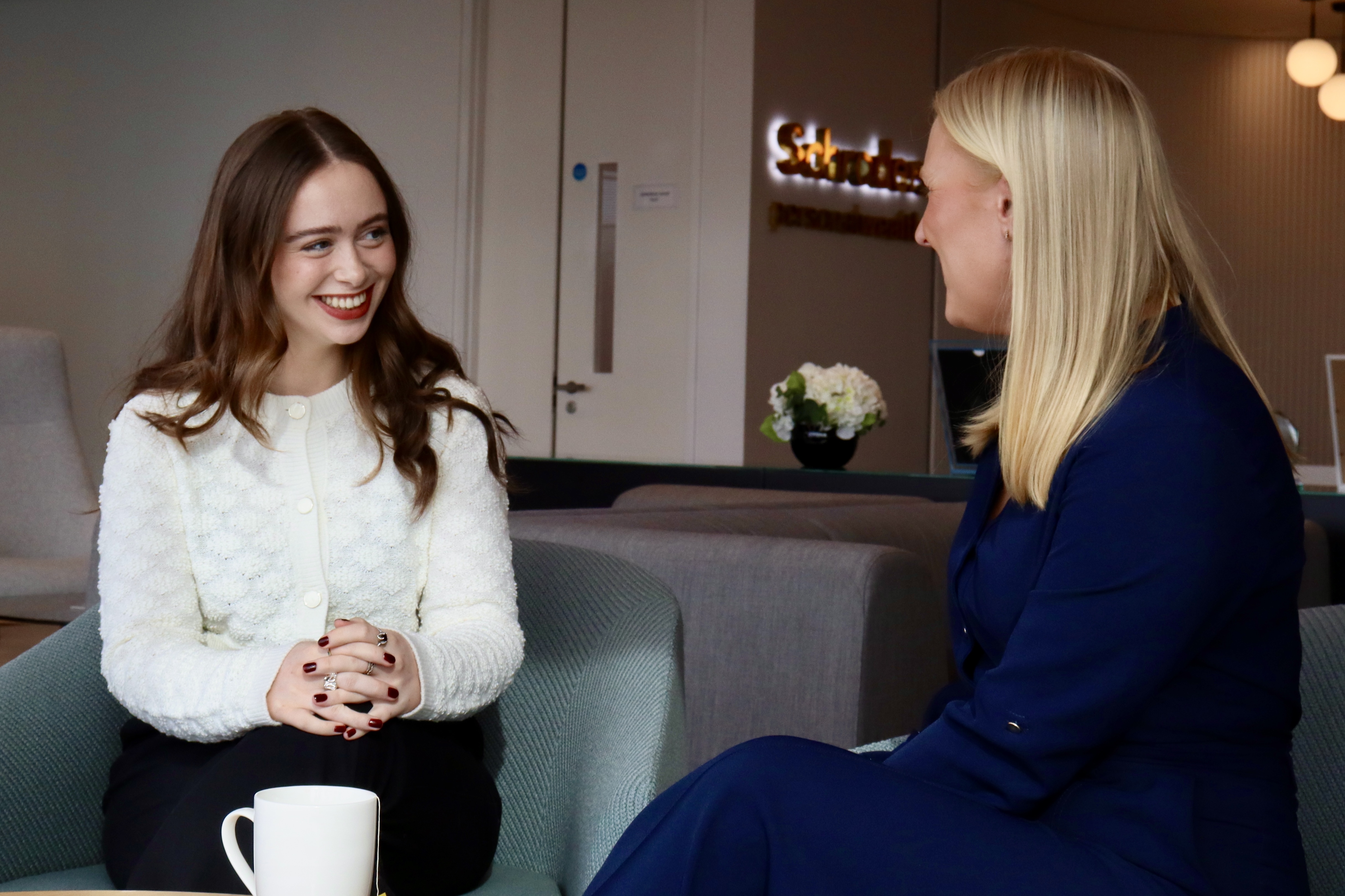 Two colleagues chatting in an office