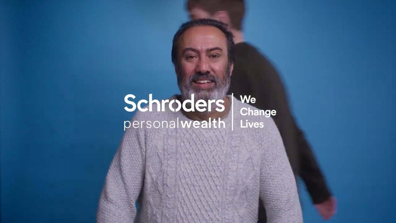 Man with blue screen behind him and SPW logo layered on top of the image